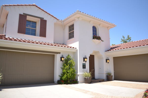 Exterior view of a home and two garages