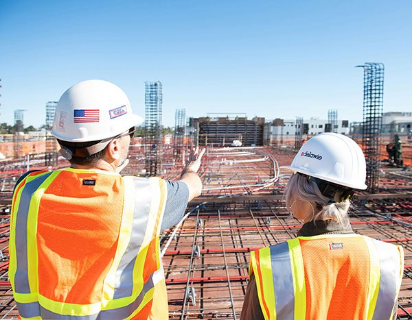 Two licensed construction contractors on a construction site